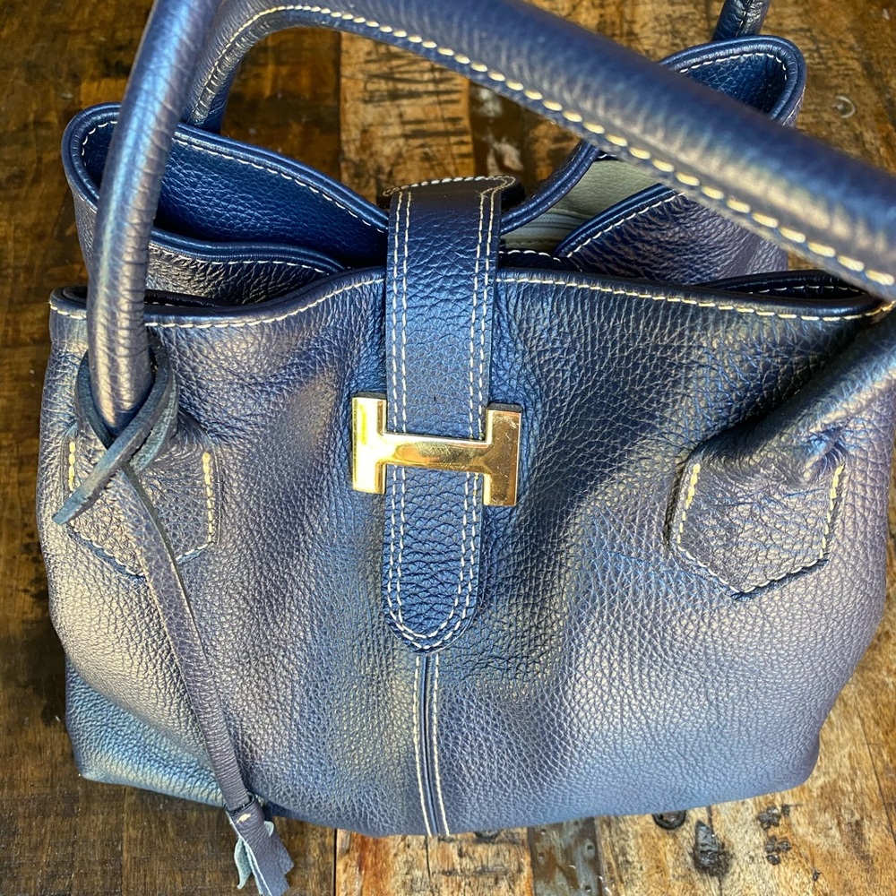 Courage b. Navy pebbled leather bag.